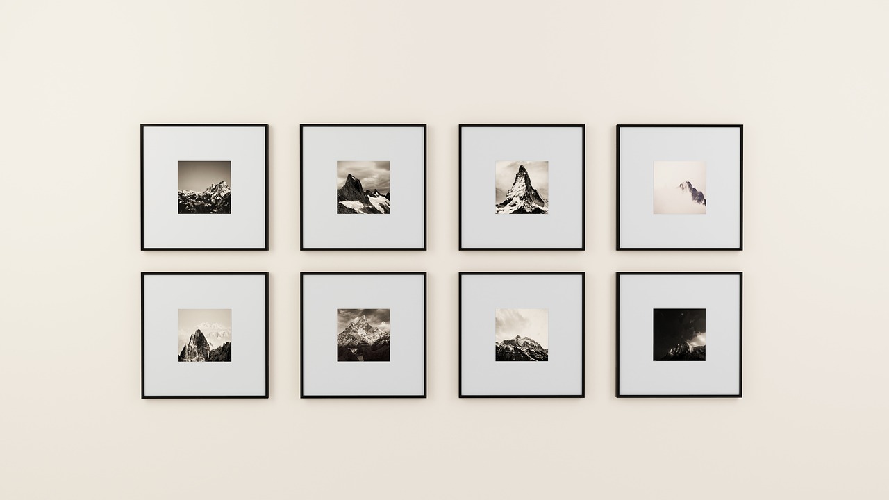 Black-and-white prints arranged on a quiet gallery wall