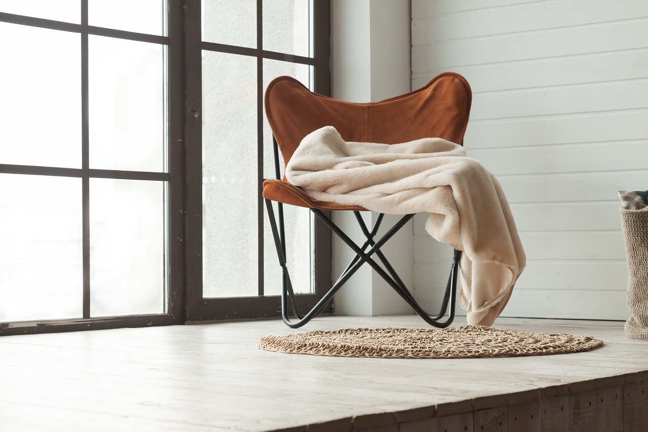 Chair beside a tall window in soft natural light